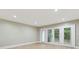 Living room with light wood floors, neutral paint, and glass doors to the backyard at 7004 Quail Hill Rd, Charlotte, NC 28210