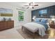 Staged bedroom with a decorative accent wall and window at 7004 Quail Hill Rd, Charlotte, NC 28210