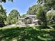Well-maintained backyard with a patio, seating, fire pit, and lush landscaping, creating a relaxing outdoor space at 8200 Lansford Rd, Charlotte, NC 28277