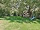 A lush backyard with a playground, mature trees, and a large grassy area perfect for outdoor fun at 8200 Lansford Rd, Charlotte, NC 28277