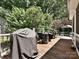 A backyard deck with a grill and patio furniture, perfect for outdoor cooking and relaxation at 8200 Lansford Rd, Charlotte, NC 28277