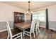 Dining room with hardwood floors, white wainscotting and a rustic wooden table at 8200 Lansford Rd, Charlotte, NC 28277