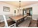 Bright dining room featuring hardwood floors and a rustic wooden table with seating at 8200 Lansford Rd, Charlotte, NC 28277