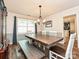 Traditional dining room with wood table, bench, and an elegant chandelier at 8200 Lansford Rd, Charlotte, NC 28277
