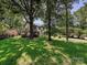Charming two-story home with a large front yard and mature trees casting shadows on the lush lawn at 8200 Lansford Rd, Charlotte, NC 28277