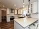 Bright kitchen features a breakfast bar, stone countertops and modern pendant lighting at 8200 Lansford Rd, Charlotte, NC 28277