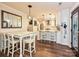 An open floorplan kitchen with white marble counters, and matching white cabinets at 8200 Lansford Rd, Charlotte, NC 28277