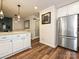 Open kitchen featuring a refrigerator, marble countertops, and modern pendant lighting at 8200 Lansford Rd, Charlotte, NC 28277
