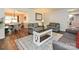 Open living room with hardwood floors, comfortable seating, and bright, natural light at 8200 Lansford Rd, Charlotte, NC 28277