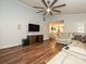 Spacious living room featuring a large wall-mount television and light colored leather sofa at 8200 Lansford Rd, Charlotte, NC 28277