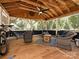Outdoor patio with wood floors, a ceiling fan, wicker furniture, a hammock, and a view of the woods at 8200 Lansford Rd, Charlotte, NC 28277