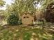 Charming outdoor shed with double doors, windows, and a black iron fence, surrounded by lush greenery at 8200 Lansford Rd, Charlotte, NC 28277