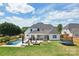 Stunning backyard with in-ground pool, lounging area, outdoor seating, and well-maintained lawn at 959 Robinson Rd, Gastonia, NC 28056