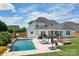 Gorgeous backyard featuring a pool, outdoor seating, lounge chairs, and spacious lawn at 959 Robinson Rd, Gastonia, NC 28056