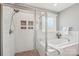 Bathroom featuring a soaking tub, tiled shower, and two built-in shelves at 959 Robinson Rd, Gastonia, NC 28056