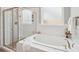 Bathroom featuring a soaking tub, tiled shower, and a frosted window at 959 Robinson Rd, Gastonia, NC 28056