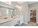 Bathroom featuring a double vanity, framed mirror, vanity space, and a walk-in closet at 959 Robinson Rd, Gastonia, NC 28056