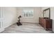 Bright bedroom featuring a wood-look floor, stationary bike, and a large dresser at 959 Robinson Rd, Gastonia, NC 28056