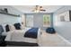 Cozy bedroom with two windows, a ceiling fan, and neutral carpeting at 959 Robinson Rd, Gastonia, NC 28056