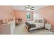 Comfortable pink bedroom with carpet and natural light from the window at 959 Robinson Rd, Gastonia, NC 28056