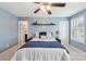 Bedroom features light blue walls, neutral carpeting, and ceiling fan at 959 Robinson Rd, Gastonia, NC 28056