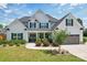 Charming home featuring a well-manicured lawn, landscaping, and a two-car garage at 959 Robinson Rd, Gastonia, NC 28056