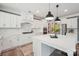 Bright, updated kitchen featuring white cabinetry, stainless steel appliances and a large center island with seating at 959 Robinson Rd, Gastonia, NC 28056