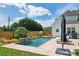 Backyard pool with basketball hoop, stone waterfall feature, and ample lounge space in a private yard at 959 Robinson Rd, Gastonia, NC 28056