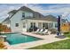 Beautiful backyard pool with outdoor lounge furniture, grill and string lights perfect for entertaining at 959 Robinson Rd, Gastonia, NC 28056