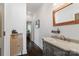 Hallway bathroom showcases a marble countertop and rustic wood mirror, offering a blend of modern and classic design at 1025 Ardsley Rd # 103, Charlotte, NC 28207