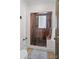 Modern bathroom featuring a glass enclosed shower with pebble floor and wood paneling at 1025 Ardsley Rd # 103, Charlotte, NC 28207