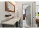 Elegant bathroom featuring a marble countertop, undermount sink and wood-framed mirror at 1025 Ardsley Rd # 103, Charlotte, NC 28207