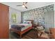 Inviting bedroom featuring wallpapered accent wall and well-lit with natural light from the window at 1025 Ardsley Rd # 103, Charlotte, NC 28207