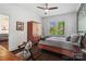 Cozy bedroom with a ceiling fan, a large wardrobe, and a window with a view of the outdoors at 1025 Ardsley Rd # 103, Charlotte, NC 28207
