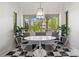 Sunlit breakfast nook featuring built-in bench seating, large windows, and stylish decor at 1025 Ardsley Rd # 103, Charlotte, NC 28207