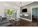 Bright living room with modern lighting, breakfast nook and dark hardwood flooring at 1025 Ardsley Rd # 103, Charlotte, NC 28207