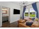 Bright living room with a stylish couch, modern lighting, and an adjacent bathroom at 1025 Ardsley Rd # 103, Charlotte, NC 28207