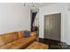 Comfortable living area featuring a leather couch and seamless access to other rooms at 1025 Ardsley Rd # 103, Charlotte, NC 28207