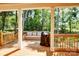 Relaxing back porch with a cozy seating arrangement, grill, and serene views of the natural landscape at 1030 Little Cowgirl Ln, Cleveland, NC 27013