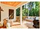 Outdoor space with a cozy seating arrangement on the back porch overlooking serene greenery and mature trees at 1030 Little Cowgirl Ln, Cleveland, NC 27013