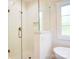Bright bathroom featuring a glass-enclosed shower with a white tile surround at 1030 Little Cowgirl Ln, Cleveland, NC 27013
