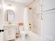 Bright bathroom featuring a shower-tub combination, with a stylish white vanity and eye-catching gold fixtures at 1030 Little Cowgirl Ln, Cleveland, NC 27013