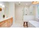 Bright bathroom featuring a glass-enclosed shower, soaking tub, and double vanity at 1030 Little Cowgirl Ln, Cleveland, NC 27013