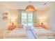 Charming bedroom showcasing twin beds, a woven pendant light, and two matching nightstands at 1030 Little Cowgirl Ln, Cleveland, NC 27013