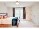 Cozy bedroom with a wrought-iron bed frame, plush blankets, and decorative buffalo check curtains at 1030 Little Cowgirl Ln, Cleveland, NC 27013