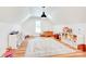 Spacious bonus room with natural light, wood floors, white shelves and a playful atmosphere for various activities at 1030 Little Cowgirl Ln, Cleveland, NC 27013