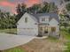 Stunning two-story home featuring a manicured lawn, welcoming front porch, and attached two-car garage at 1030 Little Cowgirl Ln, Cleveland, NC 27013