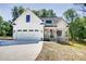 Charming new construction two-story home with an attached two car garage and rocking chair front porch at 1030 Little Cowgirl Ln, Cleveland, NC 27013