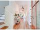 Inviting foyer with wood floors, elegant lighting, and a glimpse into the open-concept living space at 1030 Little Cowgirl Ln, Cleveland, NC 27013
