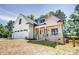 Eye-catching two-story house featuring a stylish garage, porch and a beautifully maintained front yard at 1030 Little Cowgirl Ln, Cleveland, NC 27013